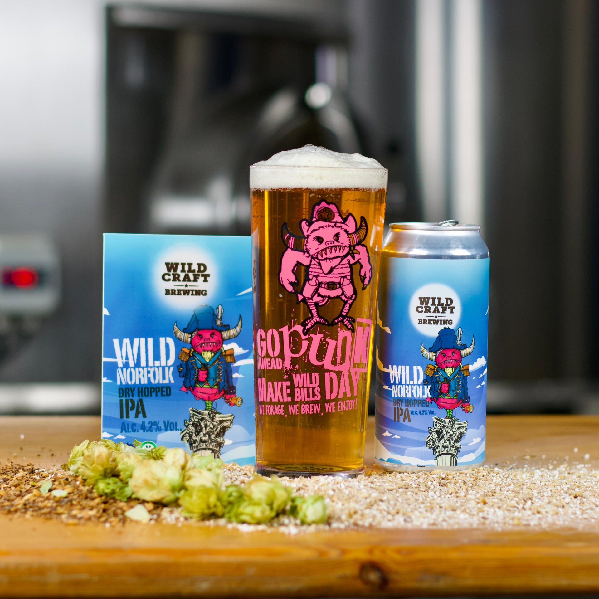 Can of beer and a glass with foam on a wooden surface, with a blurred background.