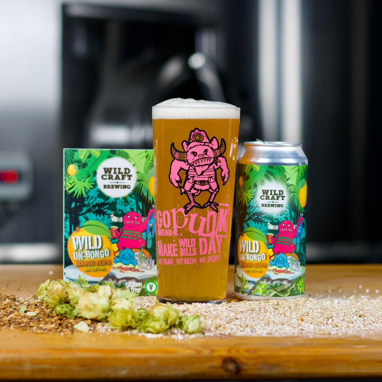 Cans of Wild Un-Bongo beer on a wooden surface with a blurred background