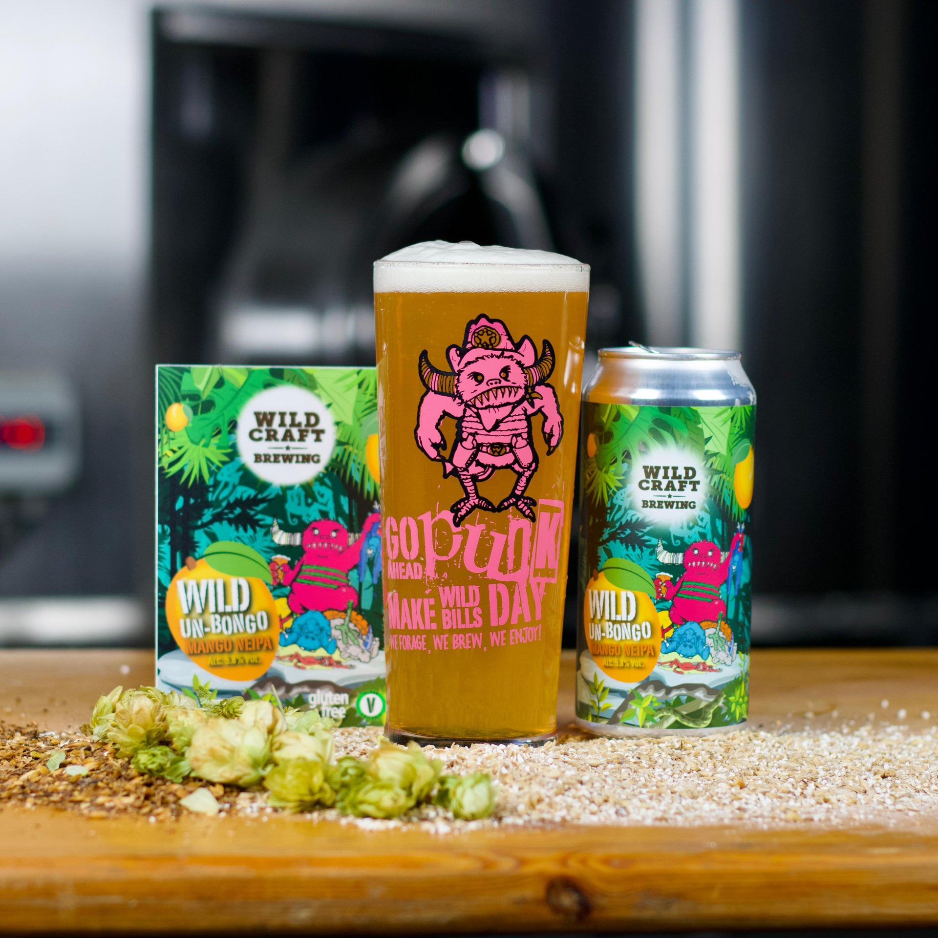 Cans of Wild Un-Bongo beer on a wooden surface with a blurred background