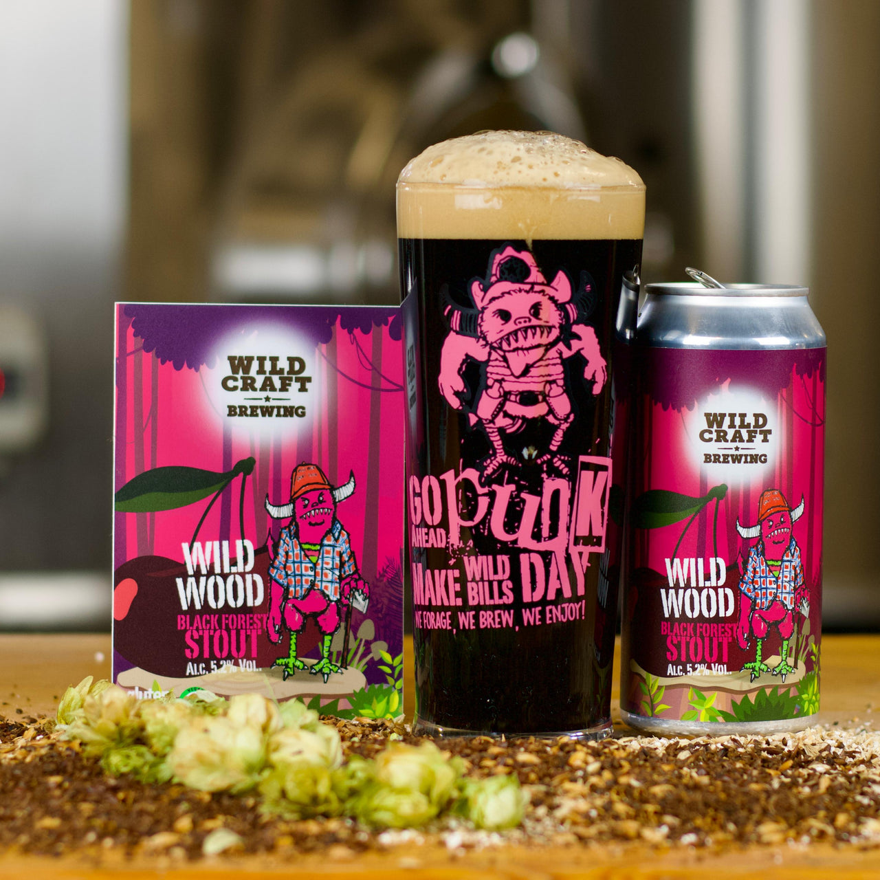 Can of Wild Wood beer on a wooden surface with a blurred brewery background.